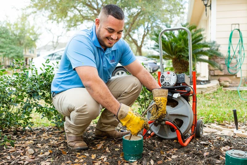 Licensed plumber performing sewer line inspection