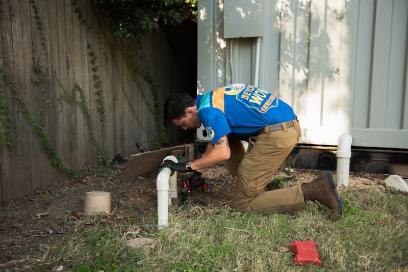 Licensed plumber performing sewer line inspection