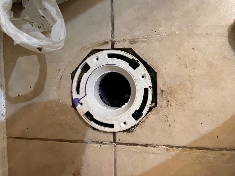 Licensed plumber performing sewer line inspection